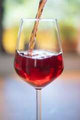red wine pouring into glass