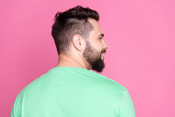 Side profile rear view photo of cheerful guy with beard dressed green t-shirt look at sale empty...