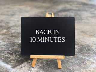 Business and management concept. BACK IN 10 MINUTES written on a blackboard.