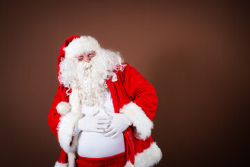 Funny fat Santa Claus dreams of a sports figure. A man is doing fitness.