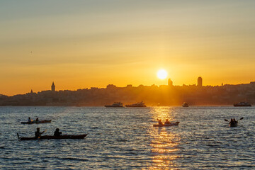 Naklejka premium Canoes are sailing on the Bosphorus in İstanbul at the sunset