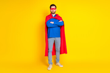 Full size photo of pretty young male confident superman wear trendy blue outfit isolated on yellow color background