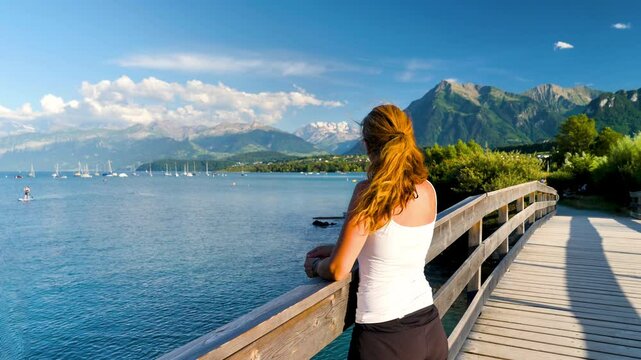 happy woman relaxing by the lake in sunny day- Switzerland