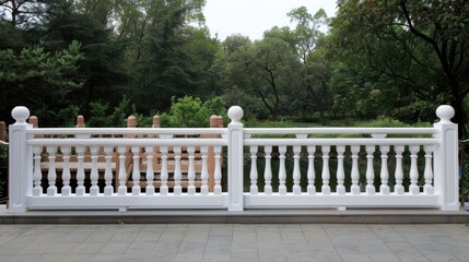 A white stone bridge with ornate railings leads through lush green gardens