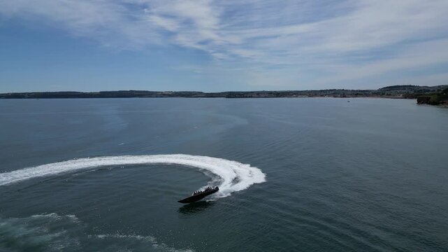 Torbay, South Devon, England: DRONE VIEWS: A large rib boat speeds across the bay. Torbay is a popular English holiday destination and a magnet for sailing enthusiasts (Clip 2).