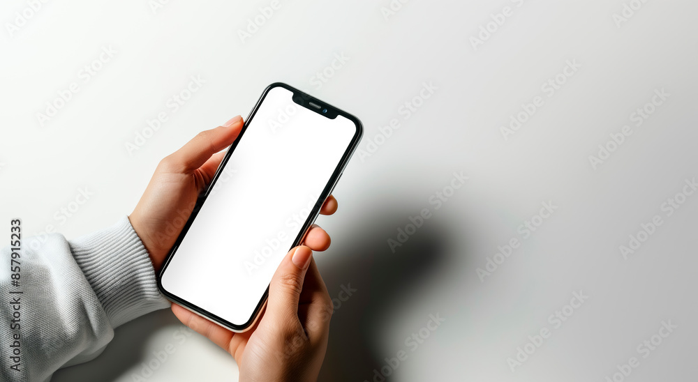 Poster hand holding a smartphone with a blank screen, ideal for mock-up, on a white background with shadow,