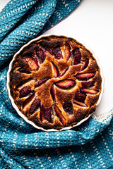Plum tart with blue fabric overhead