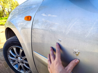 A close up image showing rust damage along the edge of a car