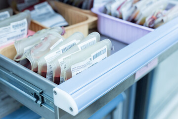 Close up red blood bag in storage blood refrigerator at blood bank unit laboratory.Save life and...