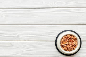 Food and treats for pets - biscuits in a shape of heart in a bowl