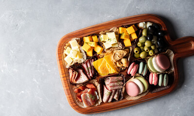 Raw ham, olives and cheese on a plate	