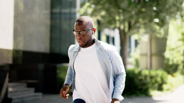 Fast-paced African American courier delivering mail