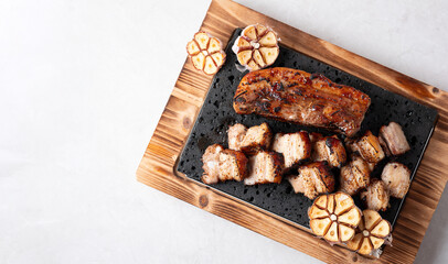 Oven-baked meat on a stone plate	
