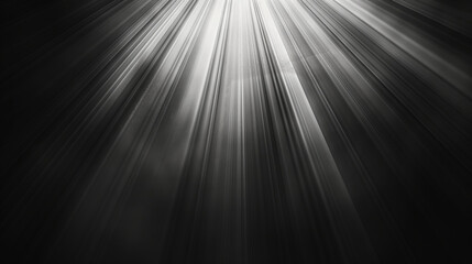 Fototapeta premium This black and white image captures light beams radiating through darkness, creating a dramatic and mystical atmosphere with vivid contrasts and ethereal quality.