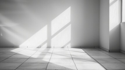 Minimalist white interior with sunlight casting sharp shadows on a tiled floor background