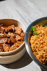 noodle bento in metal bowl and sesame chinese chicken