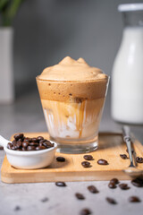 cup of Dalgona coffee decorated with coffee beans