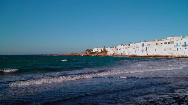 Summer seaview of Naousa of Paros in Greece. Small waves and sunny clear blue sky