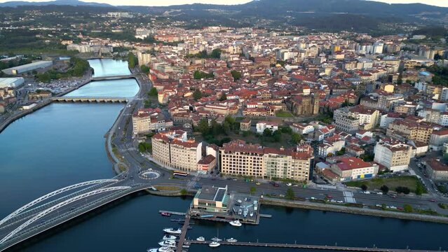 Panoramic aerial view of Spanish Galician city PONTEVEDRA. View of old town center with historic buildings. Cathedral of Pontevedra. River Lerez crossing the city. Famous travel destination. Backwards