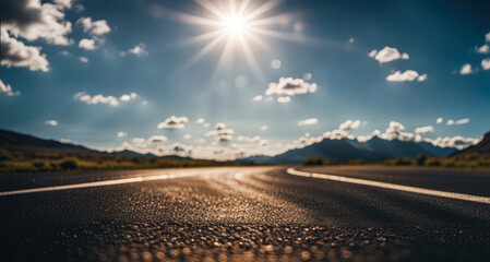 Fototapeta premium Road in the mountains with blue sky and white clouds in background.