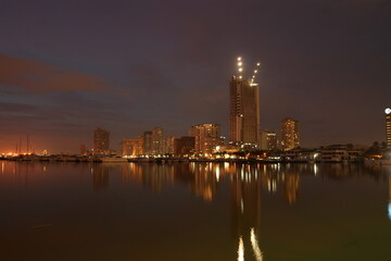 Fototapeta premium Manila cityscape at night from sea with reflections