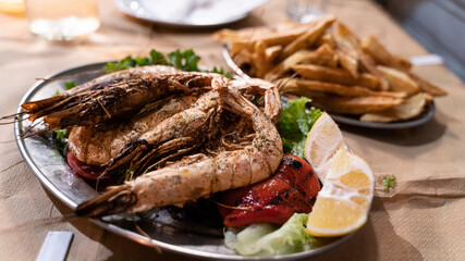 Grilled giant shrimp with french fries and garnish