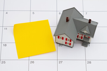 Mortgage payment due with house and sticky note on a calendar