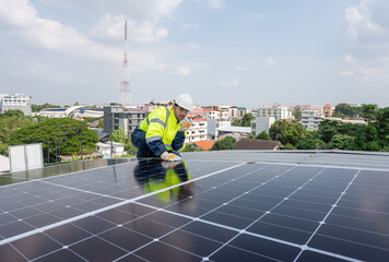 Engineer service check installation solar cell on the roof of factory. Silhouette technician inspection and repair solar cell on the roof of factory. Technology solar energy renewable.