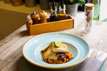 Top down of Grilled Halibut fish with Andalusian Ratatouille and a slice of lime