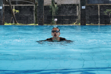 Potrait Of Young Asian Female In Swimsuit Showing Butterfly Style And Take A Breath In Pool Arena...