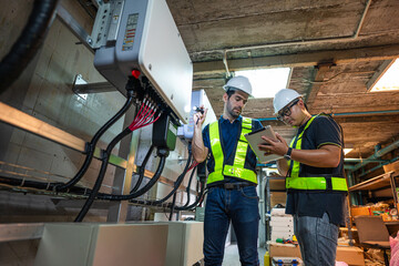 Service Engineer use tablet working inspection installation inverter solar cell. Technician...