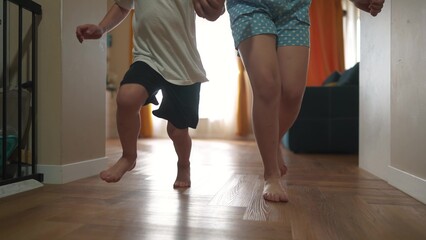 Children running indoors at home. Group friendship family kid dream concept. group of children run play around a home. Children bare feet running holding hands fun indoors. happy childhood concept.