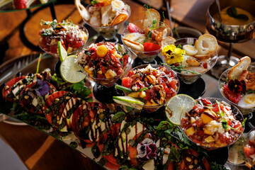 Luxury catering seafood snacks with shrimp, ceviche, and lime slices drizzled with balsamic glaze