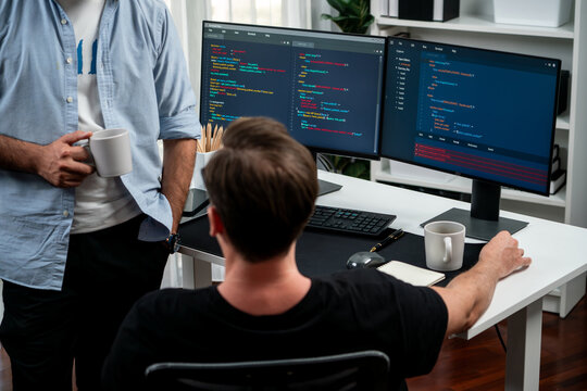 IT developers discussing online software development information on pc screen, creating program coding for latest version application on website. Concept of brainstorming firmware updated. Sellable.