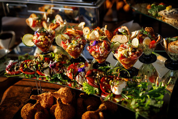 Vibrant gourmet appetizers, elegantly presented in glassware and bowls, adorned with fresh herbs and colorful vegetables