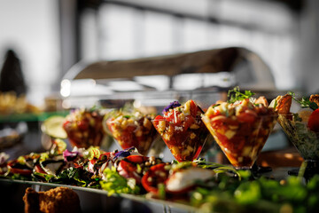 Vibrant gourmet appetizers, elegantly presented in glassware and bowls, adorned with fresh herbs and colorful vegetables