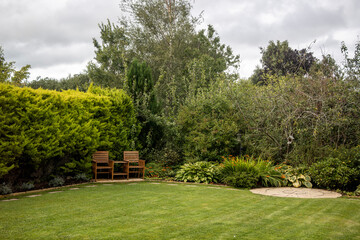 Summer garden with 2 seater wooden garden bench love seat Jack & Jill love seat