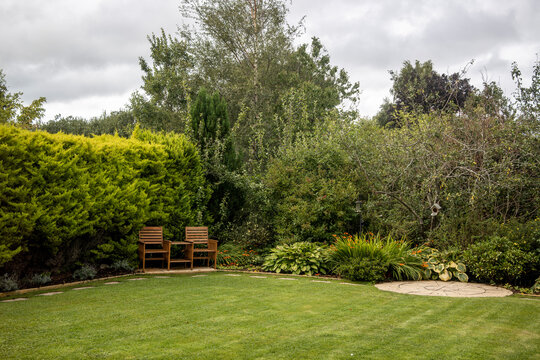 Summer garden with 2 seater wooden garden bench love seat Jack & Jill love seat