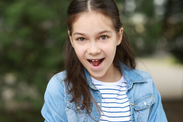 Fototapeta premium Portrait of emotional little girl outdoors. Cute child