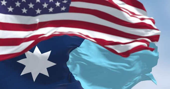 Close-up of Minnesota new state flag waving with the american flag on a clear day