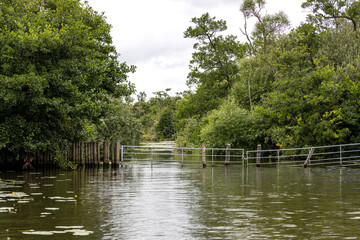 Metal and post gate across entrance to private area on River Bure Norfolk Broads