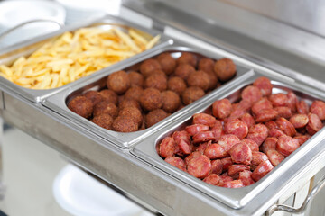 spicy sausage, kibbeh and potatoes served in a pan
