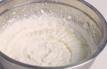 white whipped cream in metal bowl