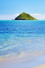 Island, tropical and mountain with ocean in nature, paradise environment background or Maldives lagoon destination. Blue sky, water and pacific peace, palm vacation and travel adventure of location