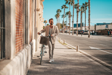 A Caucasian male entrepreneur wears a suit while pushing a bicycle on an urban street, symbolizing eco-friendly commuting habits.