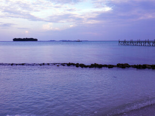 tropical beach with turquoise waters with wooden pier