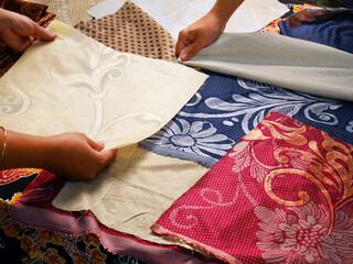 Colorful fabrics and textiles catalog on table
