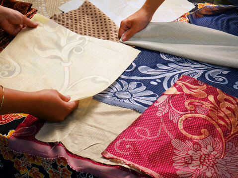 Colorful fabrics and textiles catalog on table