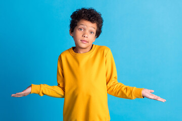Photo of nice little schoolboy shrug shoulders wear pullover isolated on blue color background