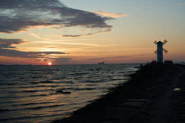 Fototapeta premium old fashioned windmill on the pier the coastline of usedom.